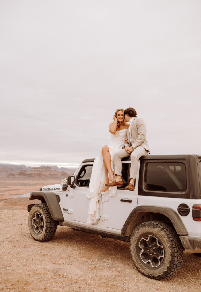 kisses on top of the jeep