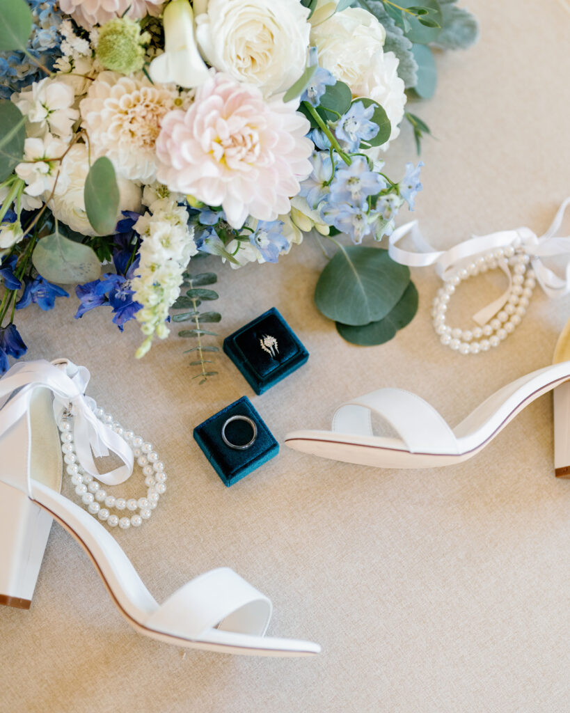 Detail shot of the bouquet, rings, and heels