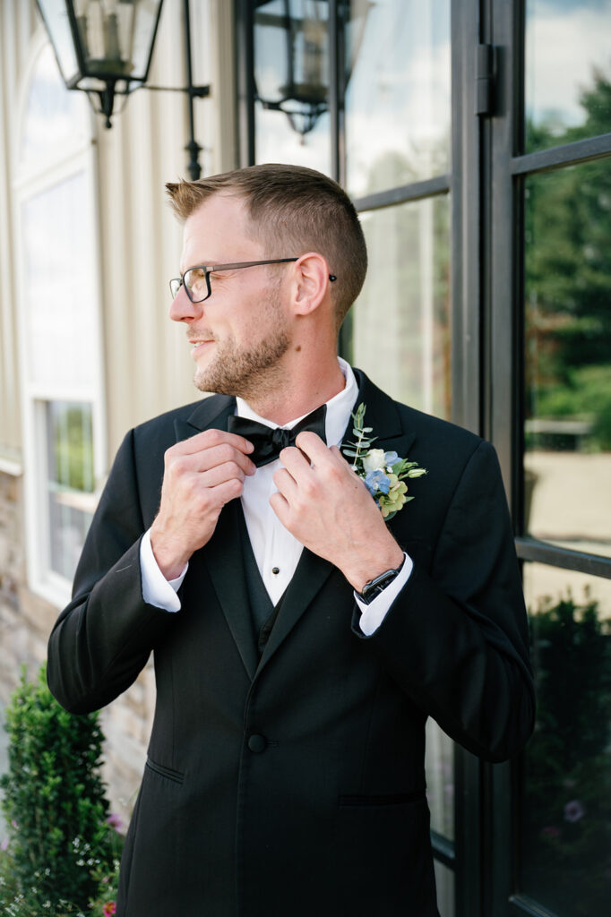 Groom smiling during groom portraits