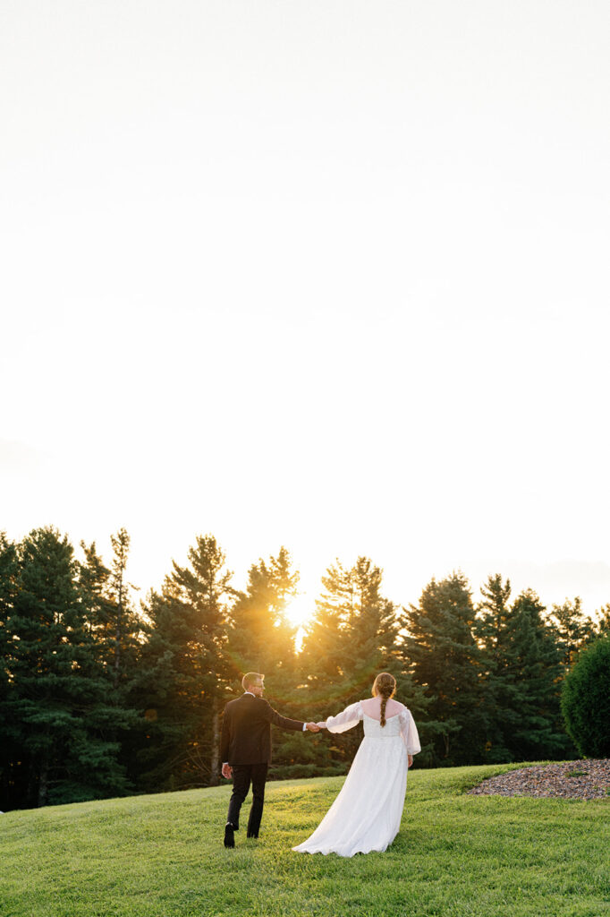 Allison and Nick holding hands against the mountain backdrop.