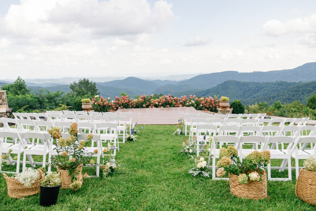 Stunning ceremony spot at The Summit at Cross Mountain with natural, lush greens and florals.
